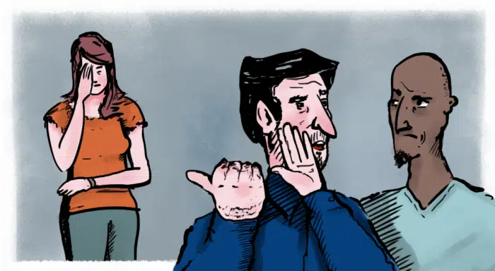 two men whispering about a woman at work